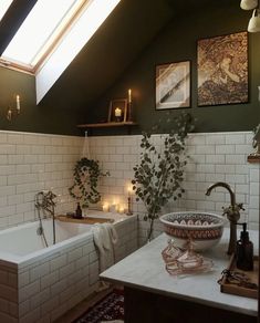 a bath room with a tub a sink and candles