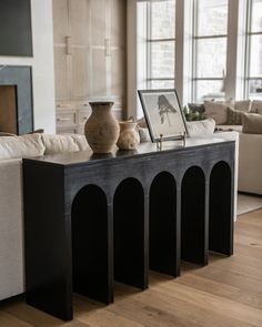 a table with vases on it in a living room