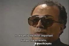 a man wearing sunglasses with a quote on the side that says to dream is the most important human characteristics