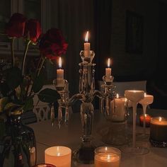 a table with candles and roses on it