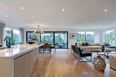 a kitchen and living room are separated by an open floor plan with sliding glass doors