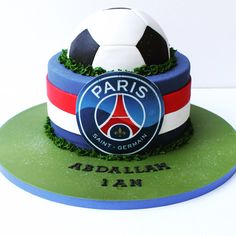 a soccer ball on top of a cake with the name paris saint - germain in front of it