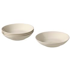 three white bowls sitting next to each other on top of a white tableware set