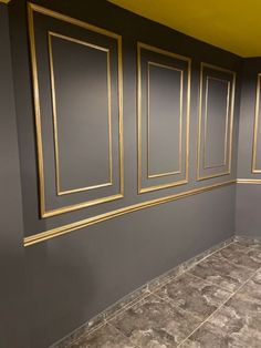 a bathroom with gray walls and gold trim