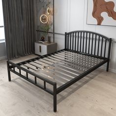 a black metal bed frame in a bedroom