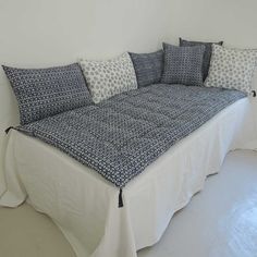 a bed with four pillows on it in a room