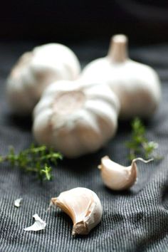 three garlics and some herbs on a table with a quote about the best thing to do with garlic