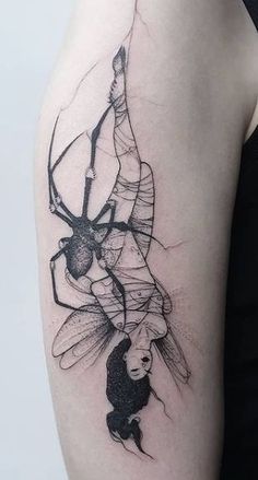 a woman's arm with a spider tattoo on the left side of her body