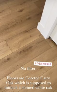 a white refrigerator freezer sitting on top of a wooden floor