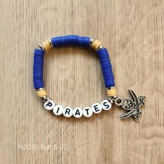 a bracelet with the word pirates written on it and a small charm attached to it