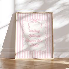 a pink and white striped poster on the floor