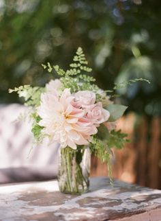 a vase filled with flowers sitting on top of a table