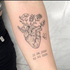 a tattoo with a heart and flowers on it