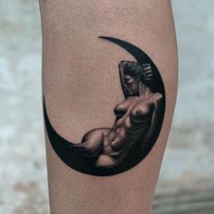 a woman's naked body is depicted in the shape of a crescent moon tattoo