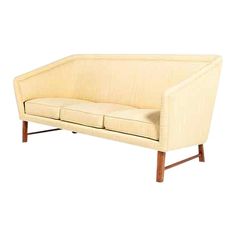 a white couch sitting on top of a wooden frame