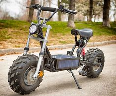 an electric scooter is parked on the side of the road in front of some trees