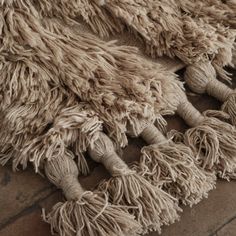 a close up of a rug with fringes on the floor and one piece of yarn hanging from it's end