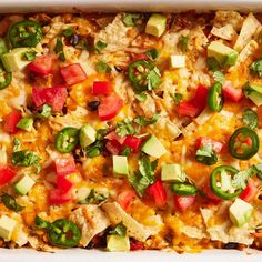 a casserole dish filled with chicken, cheese and veggie toppings