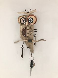 an owl made out of wood with keys attached to it