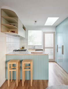 two stools are in front of the kitchen counter