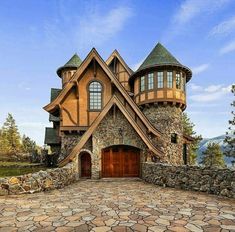 a stone and wood house with two garages