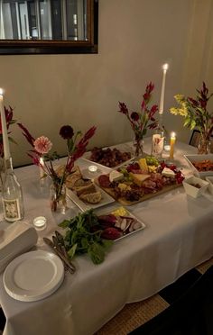 a table set with food and candles on it