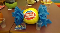 there is a giant bubble bubble ball on the table with cups and napkins around it