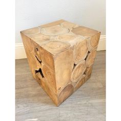 a wooden block that has been carved into a cube with circles on the top and sides