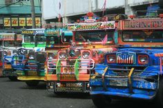 colorful buses are lined up on the street