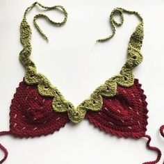 a red and green crocheted bralet on a white surface