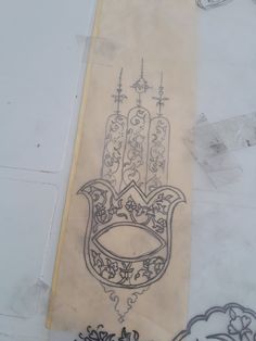 a drawing of a hamsa hanging on the wall