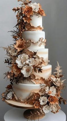 a three tiered wedding cake decorated with flowers