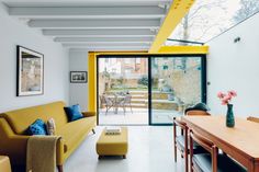 a living room filled with furniture and a sliding glass door