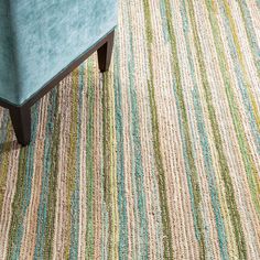 a blue chair sitting on top of a rug