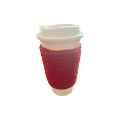 a red knitted cup sleeve with a white lid