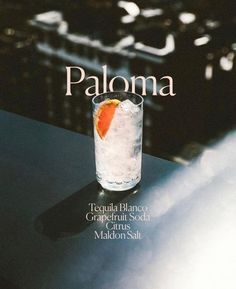 a magazine cover with an orange slice in a glass filled with ice on top of a table