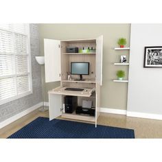 a computer desk with a monitor, keyboard and mouse