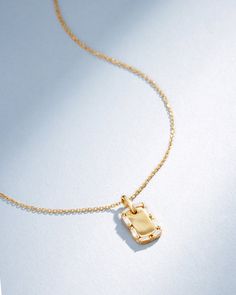 Inspired by classic design with a contemporary flair, our Golden Mini Dog Tag Diamond Pendant reflects Suzanne's signature style. This pendant features a sleek 18-karat gold dog tag, beautifully framed by a row of sparkling diamond baguettes. It's a versatile and elegant necklace, perfect for adding a touch of sophistication to your daily attire. Details 18k yellow gold, rose gold or white gold 0.13 carats of baguette white diamonds Measures 18" inches in length, adjustable at 16" inches Lobster Luxury Tarnish Resistant Jewelry, Luxury Everyday Necklace With Rectangular Pendant, Luxury Rectangular Pendant Necklace For Everyday, Luxury Gold Dog Tag Necklace, Gold Rectangular Pendant With Baguette Diamonds, Elegant Dog Tag Necklace For Anniversary, Elegant White Gold Dog Tag Necklace, Elegant Everyday Dog Tag Necklaces, Elegant Everyday Dog Tag Necklace