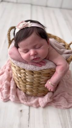 a newborn baby is sleeping in a basket