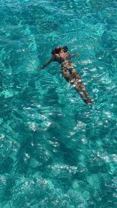 a man is swimming in the clear blue water