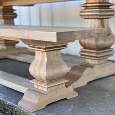 a wooden table sitting on top of a cement floor