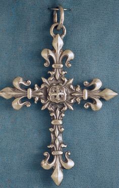 an ornate silver cross on a blue background