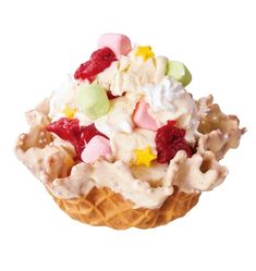 an ice cream sundae topped with fruit and whipped cream, on a waffle cone