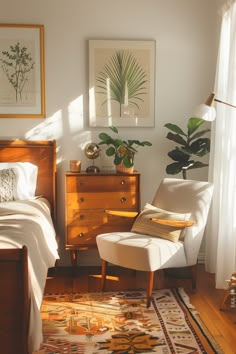 a bed room with a neatly made bed and a chair next to a dresser under a window