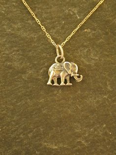 This solid 3 Dimensional original Elephant pendant is 14K Gold. The included chain is a 14K Gold chain. You may chose 16, 18 or 20 inch at the same price. Other length available at sightly higher prices.The Elephant pendant measures 9/16" tall by 13/16" long. I hand cast all my pieces using the lost wax casting method. Please ask your needs. You may call me with questions, often I am out so please use my machine. 831-476-3176. Satisfaction Guaranteed! This piece is made and ready to ship I send Gold Elephant Pendant, Gold Elephant, Elephant Pendant, Wax Casting, Lost Wax, Hand Cast, Sterling Silver Chains, Pendant Necklaces, Call Me