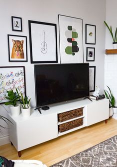 a flat screen tv sitting on top of a white entertainment center in a living room