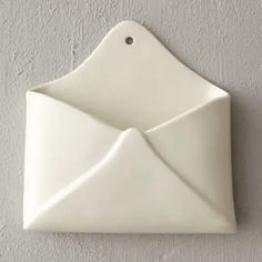 an origami envelope hanging on the wall