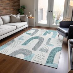 a living room with a white couch and blue rug