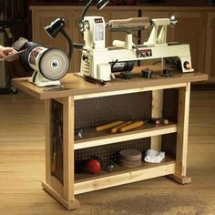 a woman is using a sewing machine to sew something on a wooden table in a kitchen