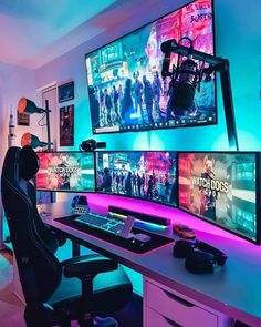 a person sitting at a desk with three monitors